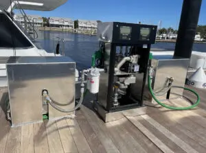 A boat is docked with two pumps on the dock.