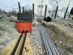 A train track with two pipes and some wires