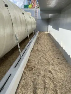 A cement wall with some grass growing on it