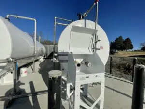 A white tank sitting on top of concrete.