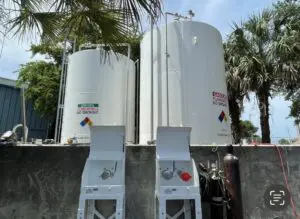 Two large white tanks sitting next to each other.