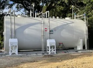 A white tank with trees in the background