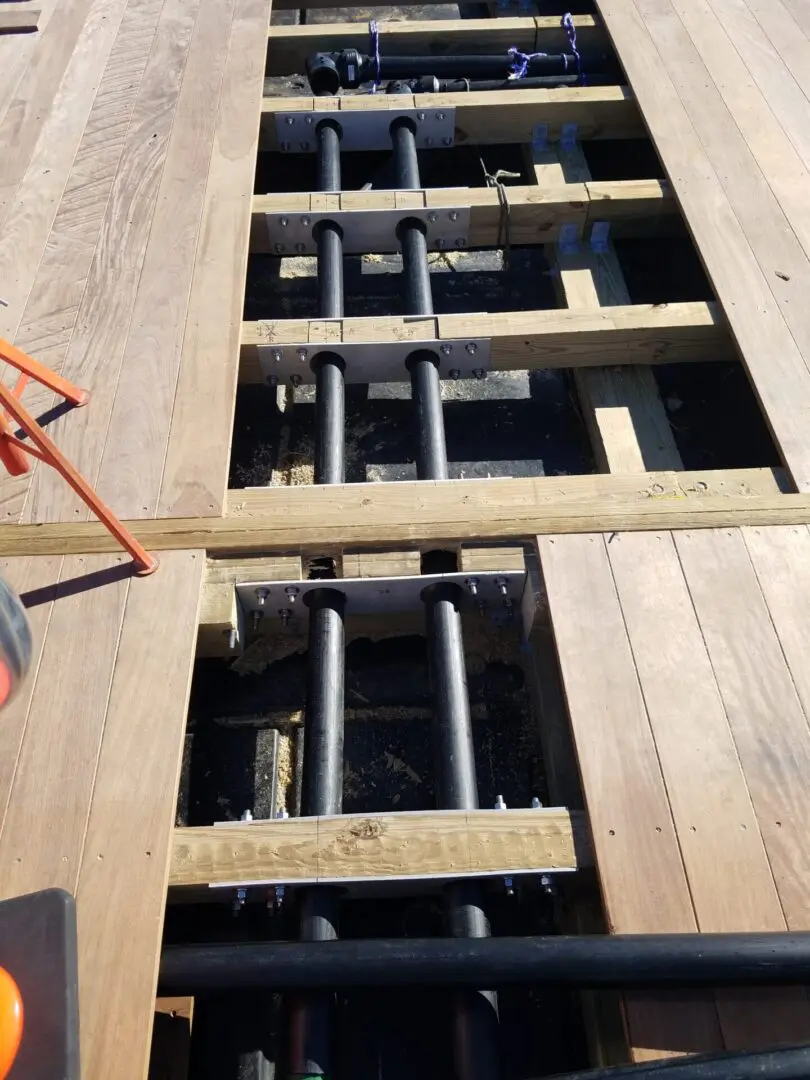 A wooden floor being constructed with metal bars.