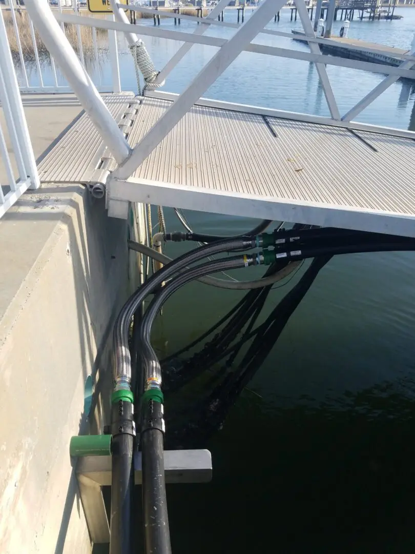 A dock with pipes and wires connected to it.