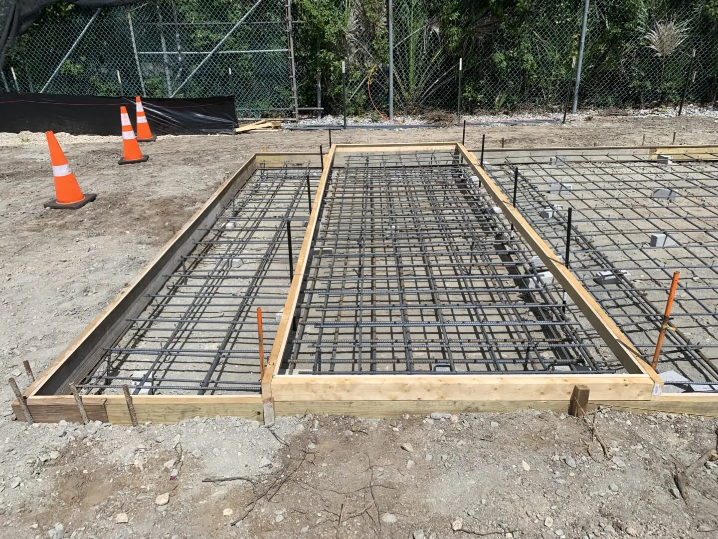 A concrete slab being poured for the construction of a house.