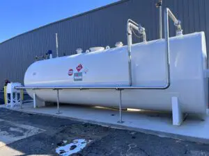 A white tank sitting in front of a building.