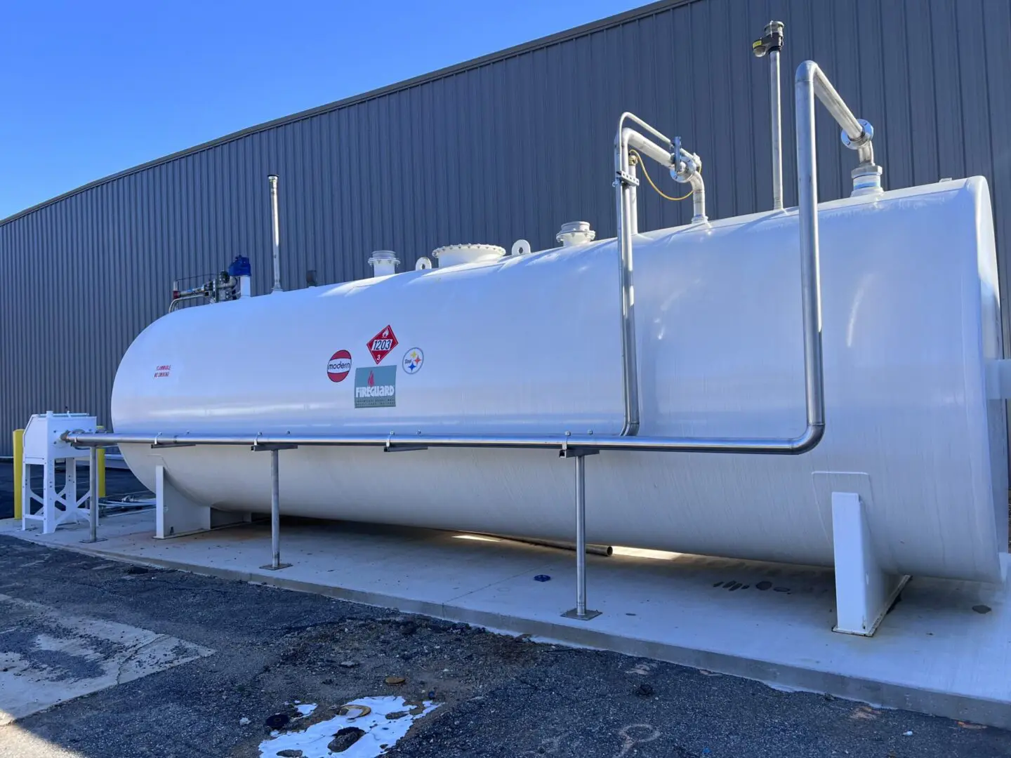 A white tank sitting in front of a building.